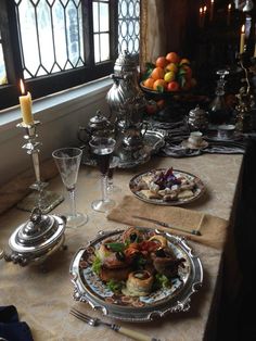 the table is set with silverware and food