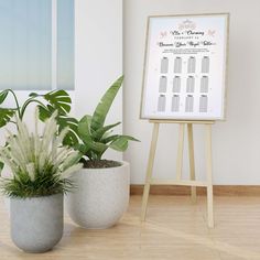 two potted plants are next to a white board with the wedding date on it