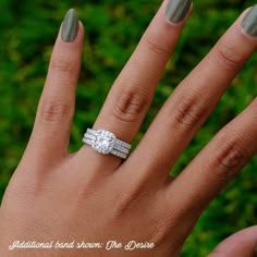 a woman's hand with two wedding rings on her left and the middle finger