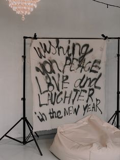 a white bag sitting on top of a floor next to a wall covered in graffiti