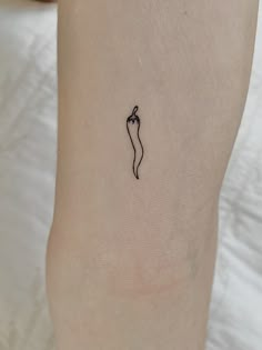 a small tattoo on the ankle of a woman's leg with a chili pepper