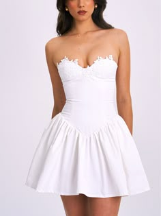 Introducing the stunning Sacha drop waist dress in crisp white, the perfect blend of style and confidence for summer. This chic mini dress boasts a timeless hue that exudes elegance, ensuring you stand out in any crowd. Crafted with a non-slip band for secure wear and functional pockets, you can dance the night away without worry. The delicate lace trim on the top adds a touch of sophistication, enhancing the allure of this eye-catching piece. Whether you're attending a cocktail party or a night Feminine White Corset Dress With Sweetheart Neckline, Elegant Fit And Flare Corset Dress For Spring, Brunch Mini Dress With Fitted Bodice, White Flirty Mini Hem Dress, Elegant Mini-length Summer Corset Dress, Elegant Summer Mini Length Corset Dress, Chic Mini Length Corset Dress For Brunch, White Mini Dress For Casual Wear, Elegant Summer Mini Corset Dress