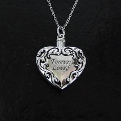 "A necklace that is not only beautiful, but functional! Heart Ash Container Necklace, Cremation jewelry, Pet Ashes. This pendant measures 25x28mm, (1\" wide). It unscrews at the top to hold your precious memories that will rest next to your own heart. I dropped it from a Sterling Silver chain that has a spring clasp and a 'Theresa Mink' signature tag attached. Choose your length in the option bar. Included is a black pouch, funnel, spoon, and toothpick. I also offer the love drop and the infinit Heart Container, Black Pouch, Clean Sterling Silver, Ashes Necklace, Silver Pendant Lighting, Filigree Heart, Pet Ashes, Golden Jewelry, Cheap Jewelry