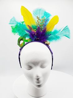 Mardi Gras headband made with purple, gold and green feathers with gold sparkle embellishments. Green masquerade mask with gold glitter detail and feathers. Headband wrapped with purple ribbon. Perfect for Mardi Gras celebration, carnival, festival or photoshoot. Adjustable Costume Accessories For Mardi Gras, Adjustable Masquerade Mask For Mardi Gras, Carnival Masquerade Headband Headpiece, Carnival Masquerade Headband, Purple Mardi Gras Costume Accessories, Masquerade Carnival Headband, Mardi Gras Feathered Masquerade Mask For Party, Headband For Mardi Gras Carnival, Adjustable Costume Accessories For Mardi Gras Carnival