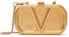 Sculptural shoulder bag in antiqued gold-tone featuring logo embossed at face. · Detachable curb chain shoulder strap · Tab-slot fastening · Grained leather lining in red · H3 x W5 x D1 in Supplier color: Antique brass | Valentino Garavani Gold Mini VLogo Shoulder Bag Gold Bag, Fancy Bags, Valentino Women, Valentino Bags, Curb Chain, Clutch Handbag, Valentino Garavani, Antique Gold, Antique Brass