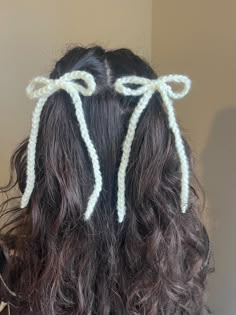 the back of a woman's head with two hair clips attached to it