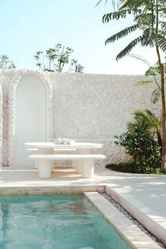 a pool with a table and chairs next to it