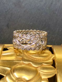 a close up of a wedding ring on top of a gold object