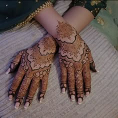 two hands with henna designs on them