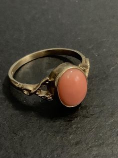 9ct gold hallmarked coral ring  The peachy orange gem is 10x8mm  A natural coral , hallmarked 1988. Now it is illegal to lift coral , but this was made before that rule. Bound to become rare and expensive as a result.  Size Q1/2.      Usa 8.25  In excellent condition.