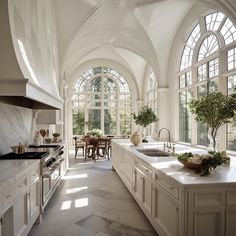 a large kitchen with an arched ceiling and marble counter tops