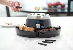 Experience the interactive fun of s’mores all year ’round with our Electric S’mores Maker. There are no dangerous flames to worry about. The Electric S'mores Maker uses a stainless steel electric heater to warm your marshmallows to toasty, gooey perfection. Load the four tray compartments with graham crackers, chocolate squares, marshmallows and other goodies... and let the fun begin. Try it at a party for an instant conversation starter! Includes four stainless steel s’mores sticks... Butterscotch Chip Cookies, Best Juicer Machine, Shed Shop, Smores Maker, Kitchen Cabinet Pantry, Electric Roaster, Electric Ice Cream Maker, Best Juice, Mini Waffle Maker