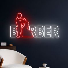 a neon sign that says barber in front of a black wall with a white chair