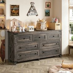 a dresser with many items on top of it in a room filled with pictures and decor