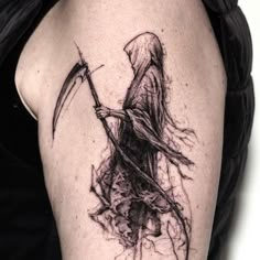 a woman with a scythe tattoo on her arm