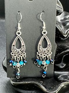 Handmade earrings with blue faceted beads. The earrings are 7 cm long. Blue Metal Chandelier Earrings With Dangling Beads, Blue Metal Beaded Earrings For Gift, Blue Metal Crystal Earrings With Ear Wire, Blue Crystal Earrings With Metal Ear Wire, Blue Metal Chandelier Earrings For Pierced Ears, Blue Metal Chandelier Earrings With Ear Wire, Blue Metal Beaded Dangle Earrings, Metal Earrings With Faceted Beads For Party, Handmade Blue Beaded Metal Earrings