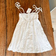 White Mini Sundress Perfect For Summer Adjustable Bow Tie Straps 24” Long (Excluding Straps) Show Me Your Mumu White A-line Sundress With Tie Straps, White A-line Mini Dress With Tie Back, White Knee-length Mini Dress With Tie Back, White Tie-back Midi Dress For Casual Wear, White Midi Dress With Tie Back, Casual White Midi Dress With Tie Back, White Cotton Dress With Tie Back, White Sundress With Tie Back, White Dress With Spaghetti Tie Straps