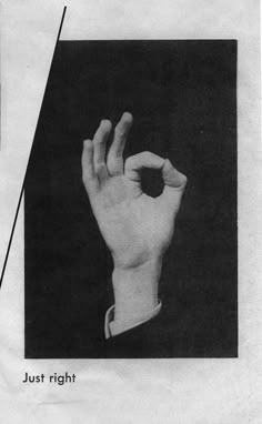 a black and white photo of a hand making the v sign