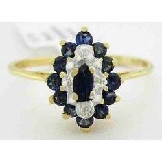 Total Carat Weight: 0.30 Carats Secondary Stone: Diamond Main Stone Color: Blue Number Of Diamonds: 4 Ring Size: 7.25 (Free Resizing Service - If Needed) Main Stone Shape: Round Base Metal: Gold Setting Style: Prong Material: Gemstone Cut Grade: Very Good Metal Purity: 10k Main Stone: Blue Sapphire Metal: Yellow Gold Blue Diamond Marquise Ring With Accents, Blue Marquise Diamond Ring With Accents, Classic Blue Diamond Ring With Accents, Blue Marquise Diamond Ring With Diamond Cut, Blue Marquise Brilliant Cut Diamond Ring, Blue Marquise Diamond Ring With Brilliant Cut, Blue Diamond Cluster Sapphire Ring, Classic Blue Marquise Diamond Ring, Blue Cluster Diamond Ring With Halo Setting