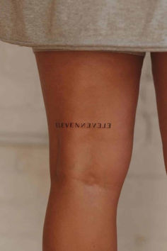 a woman's legs with the word eleven avenue written on it, in black ink