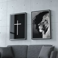 two black and white pictures hang on the wall next to a couch with a cross