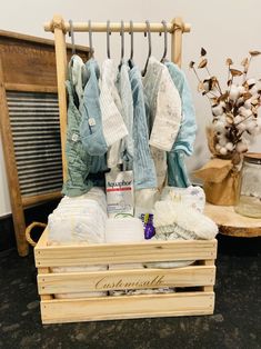 a wooden crate filled with lots of clothes and other items on top of a table