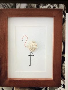 a flamingo framed in a wooden frame