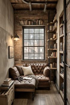 a living room filled with furniture and bookshelves next to a brick wall covered in books