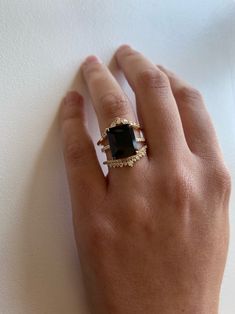 The big sister to our beloved Onyx Ring. A 5.5ct emerald cut Black Onyx is set into our signature claw prongs for a dramatic effect. The subtle, flat quarter band with 0.09tcw of Diamonds gives this piece its modern feel with just the right amount of shine. This ring will certainly turn heads! Treat with love due to the center stone softness. Band width, 1.5mm. Pictured on a size 4 finger. Can't wait? Check out our Ready To Ship pieces or send us a message! Ring Black Stone, Onyx Engagement Ring, Claw Prong, Black Onyx Ring, Put A Ring On It, Dress Rings, Onyx Ring, Dream Ring, Baguette Diamond