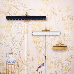 the wallpaper has birds and flowers on it, along with two tall metal poles