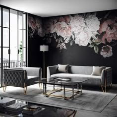 the living room is decorated in black and white with flowers painted on the wall behind it