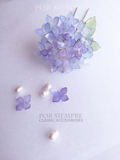 some purple flowers and pearls on a table