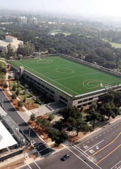 an aerial view of a soccer field and parking lot