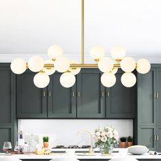 a kitchen with green cabinets and white counter tops