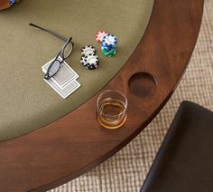 a pair of glasses sitting on top of a table next to some dice and poker chips