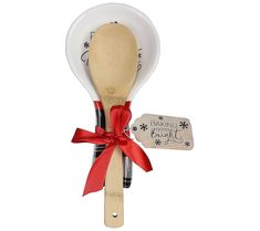 a wooden spoon with a red ribbon tied around it and a tag on the handle