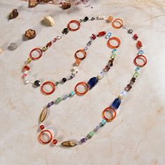 This multi-color multi-shape beautifully hand-crafted boho-style necklace is definitely an eye-catching and head-turning piece. This stunning yet affordable necklace will complement your every mood and style. -44" length/can be doubled up without a clasp https://www.etsy.com/shop/MYGEMSROCK Multicolor Handmade Lariat Necklace, Handmade Multicolor Lariat Long Necklace, Handmade Multicolor Lariat Necklace, Handmade Multicolor Long Necklace, Multicolor Gemstone Beaded Lariat Necklace, Multicolor Lariat Beaded Necklaces With Natural Stones, Multicolor Multi-strand Bohemian Necklace, Artisan Multicolor Beaded Long Necklace, Colorful Round Bohemian Beaded Necklaces