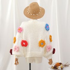 Thick chunky knit cropped cardigan with colorful puffy crochet flower pom poms all over. You're a cozy rainbow garden in this cute number. Each sweater weighs about 900g / 2lbs. 100% acrylic knit 24" across shoulders, 44" chest, 16-17" length Playful Spring Knitted Sweater, Playful Knitted Spring Sweater, Playful Knitted Sweater For Spring, Spring Crochet Acrylic Sweater, Spring Acrylic Crochet Sweater, Spring Cozy Sweater In Acrylic Yarn, Cozy Acrylic Yarn Sweater For Spring, Playful White Winter Cardigan, Bohemian Acrylic Sweater For Spring