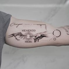 a person with a tattoo on their arm that says memory, mementoo and mori