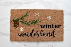 a door mat that says winter wonderland with pine cones and snowflakes on it