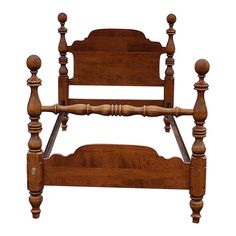 an old wooden bed frame with wood posts and spindles on the headboard, isolated against a white background