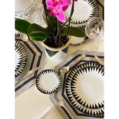 a table topped with plates and flowers on top of it