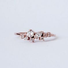 The Pixie Cluster ring is made in your choice of CZ's or natural diamonds. Pair it with our Meghan Stack Ring for the ultimate delicate look. This ring is designed and made in NYC. 14K solid gold Cz or natural diamonds 1.2mm ring band Natural diamonds version: Approx. 0.2ct. VS~SI clarity. **This item is specially made for you. Please allow 1-2 week lead time. Shipping:Domestic: Free standard shipping within the U.S.International: Free standard shipping for orders over $200 Customization:- Inter