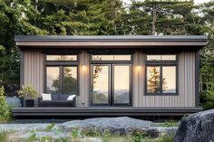 a small house with two windows sitting in the grass