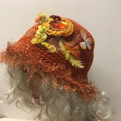 This burnt orange hat is so good for boring and colorful winter days.  It reminds you about hot summer, flowers and butterflies. All these beautiful things you see on the hat. To add more charm to this crocheted hat I trimmed the brim with a fur looking yarn. One of a kind hat. Hand crocheted with a wool blend yarn this hat is warm. Fits most of average and big adults heads. Comes from my smoke and pet free studio. To see more of my unique handmade hats, click here: https://www.etsy.com/shop/Iryna?section_id=22590274 Best wishes from Iryna Orange Bohemian Summer Hat, Trendy Crochet Hat With Curved Brim, Winter Festival Wide Brim Sun Hat, Bohemian Orange Sun Hat For Spring, Handmade Hats For Fall, One Size Fits Most, Handmade Fall Hats, One Size Fits Most, Adjustable Bucket Hat For Fall Beach Outings, Handmade Fall Hats One Size Fits Most, Bohemian Brimmed Sun Hat For Winter