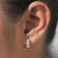 Round Moissanite Engagement Earring , Colorless Moissanite Wedding Earrings , Three Stone Moissanite Bridal Earrings , 14K Solid Yellow Gold Huggies Hoop Earring For Bride To Be , Share Prong  Moissanite Anniversary Earrings  𝐉𝐞𝐰𝐞𝐥𝐫𝐲 𝐕𝐢𝐝𝐞𝐨: https://youtu.be/d0gTDOEsV3U ✥ 𝐌𝐚𝐢𝐧 𝐒𝐭𝐨𝐧𝐞 𝐃𝐞𝐭𝐚𝐢𝐥𝐬: ↣ Shape: Round  ↣ Type: Moissanite ↣ Weight: 1.00 CTW (App.) ↣ Color/Clarity: Colorless/VVS ↣ Making Process: Handmade - Crafted by our experienced team ✥ 𝐉𝐞𝐰𝐞𝐥𝐫𝐲 𝐃𝐞𝐭𝐚𝐢 Gia Certified Round Diamond Earrings For Wedding, Elegant Round Cut Huggie Earrings For Wedding, Wedding White Cubic Zirconia Huggie Earrings, Elegant Wedding Huggie Earrings, White Cubic Zirconia Huggie Earrings For Wedding, White Round Cut Huggie Earrings For Wedding, Wedding Fine Jewelry Huggie Earrings With Cubic Zirconia, Wedding Huggie Earrings With Brilliant Cut Cubic Zirconia, Anniversary Dangle Huggie Earrings With Brilliant Cut