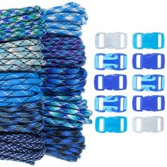 several blue and white bracelets are stacked on top of each other, with two clips attached to them