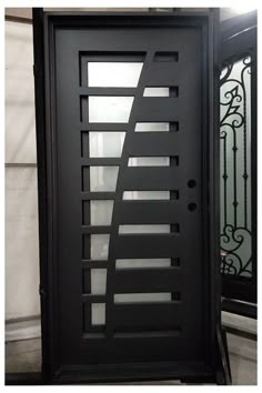 a black door with an iron design on it