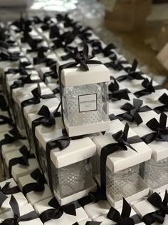 several white boxes with black bows on them