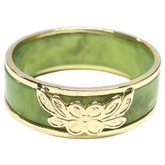 14 Karat Yellow Gold Green Jade Two-Part Ring. Two rings in one, a beautiful light sage green jade band and a yellow gold two band ring with a a four petal flower and leaves at the center. The ring measure 7mm wide and 2.4mm thick. The ring is size 8. The rings together weigh 4.06 grams. Luxury Green Engraved Men's Ring, Gold And Jade Ring, Jade Gold Ring, Bug Type Gym Leader, Green And Gold Ring, Jade Wedding Ring, Jade Engagement Ring, Green Wedding Rings, Four Petal Flower